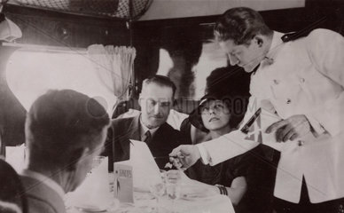 Steward serving lunch in the cabin of an Imperial Airways Scylla  1934.