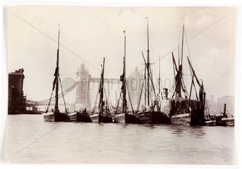 Boats moored at Tower Bridge  1890s.