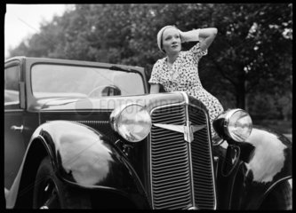Woman beside an Adler motor car  Germany  c 1934.