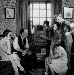 Family listening to a speech by Winston Churchill  19 May 1945.
