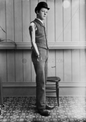 Man wearing an artificial arm  1890-1910.