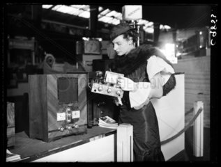 Woman inspecting an Aerodyne radio  Radiolympia  Olympia  London  1934.