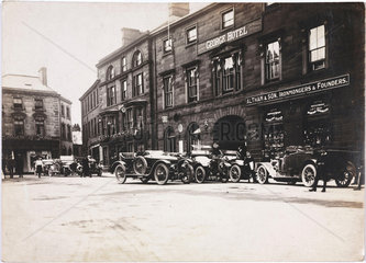 Motor cars parked outside a hotel  c 1912.