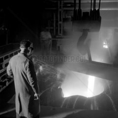 Man stokes an air furnace in the roll foundry of Davy United   Billingham.