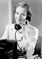 Typist answering the telephone  1949.