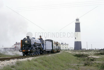 Miniature train passing a lighthouse  Dungeness  Kent  1966.