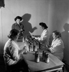 Female workers assembling barometric bomb fuses  Leeds  1953.