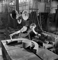 A fitter cold forms a straight steel billet into a ring at British Thomson Houston.