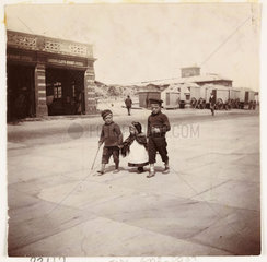Three children walking past a lifeboat station  Whitby  North Yorkshire  c 1905.