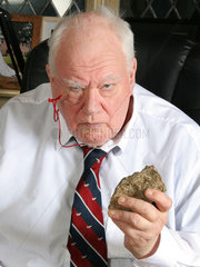 Astronomer Patrick Moore holding a piece of meteorite  2007.