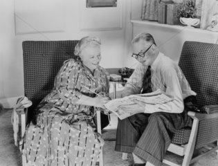 Elderly couple reading  c 1950.