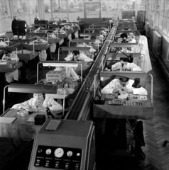 Long shot of factory workers assembling Smith watches  Rotherham  1958.