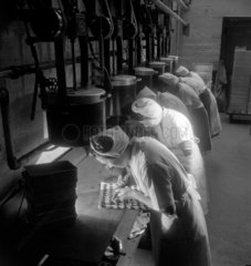 A line of female workers pipe fondant mixture onto trays at Mackintosh’s 1950.
