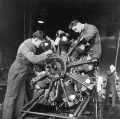 Two men repairing a Royal Air Force aeropla