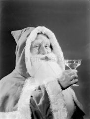 Father Christmas drinking a toast  1950.