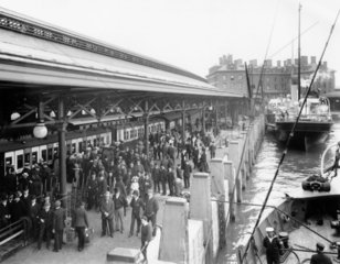 Passengers disembark from the SS 'Cedric' to join a waiting boat train  1909.