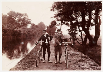 Cyclists on a towpath  c 1900.