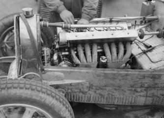 A mechanic working on the engine of a Bugatti  Nurburgring  Germany  1931.
