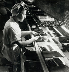 A young woman on line packing boxes of Fortune chocolates  1961.
