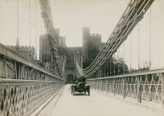 Motor car crossing a suspension bridge  Conwy  Wales  c 1912.