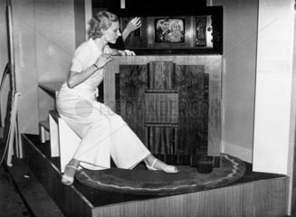 Woman watching a Marconi mirror lid television  Radiolympia  London  1936.