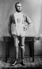 Man wearing a pair of artificial legs  1890-1910.