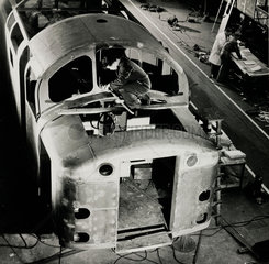 Man on top of D200 diesel engine under construction  English Electric  1957.