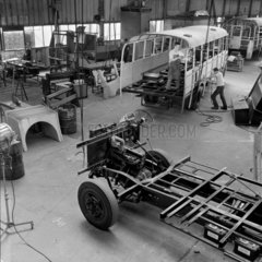 Srachan coachbuilding shop :a chassis in foreground waiting for body  1969.