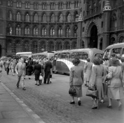 Newly arrived passengers walking to tour coaches outside St Pancras  1950.