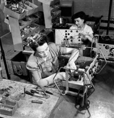 Two female workers assemble radio equipment  1952.