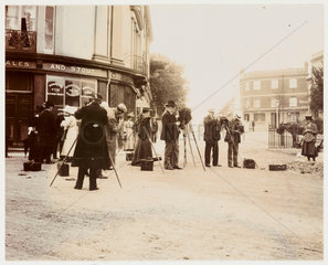 Group of photographers taking photographs in the street  19th century.