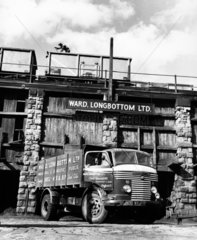 A Commer lorry collects coal from wagons on staithes in coal yard  1961.