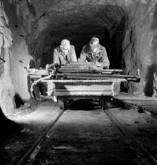 Two miners underground pushing trolley at Holman Brothers  Cambourne  1948.