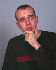 Man with hand on chin in thoughtful pose  December 2000.