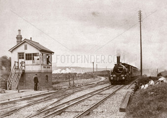 Steam locomotive passing Uphill Junction  Somerset  c 1900s.
