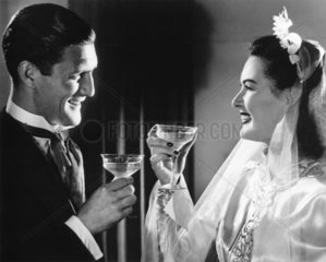 Newlyweds enjoying a glass of champagne  1940s.