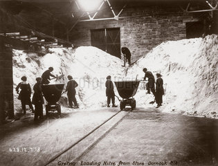 Women workers breaking up a heap of nitre  Dornock  Scotland  1918.