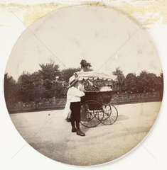 Woman  boy and a pram  c 1890.