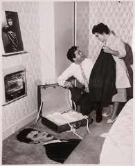 Cliff Richard packs with the help of his mother  10th October 1961.