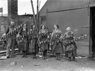 Kipper girls displaying smoked kippers  24 September 1931.