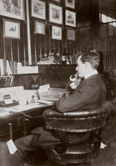 C S Rolls sitting at his desk talking on the telephone  c 1900.