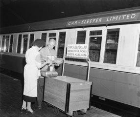 Passenger collecting food to eat on a car sleeper  20 June 1955.