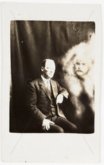 Man with 'spirit face' appearing  c 1920.