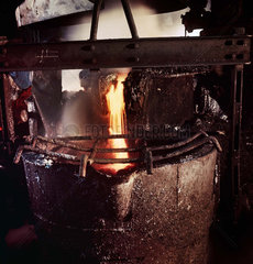 Filling a crucible with molten metal for casting  1965.