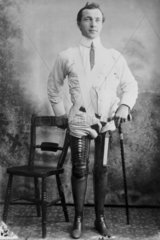 Man wearing a pair of artificial legs  1890-1910.