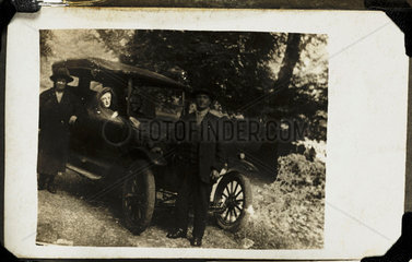 Couple with a 'spirit' in their car  c 1920..