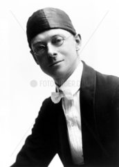 Bespectacled man wearing tight-fitting hat