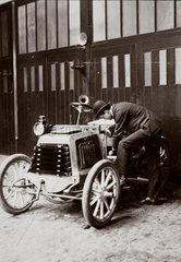 C S Rolls inspecting a motor car  c 1900.