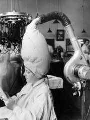 The latest hairdrying technology at a hairdressing school  8 July 1937.