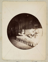 Two children sitting on a settee  1888.